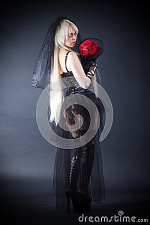 Black widow in grief with flowers with a veil