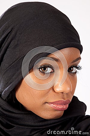 Black woman in a hijab, looking at camera