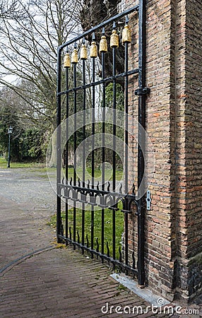 Black wrought iron gate with golden decorations