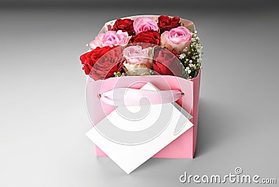 Blank greeting card over box of roses