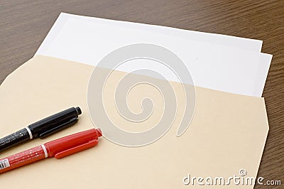 Blank paper and pen and brown envelope