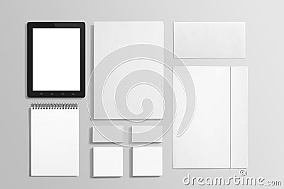 Blank Stationery and tablet isolated on grey.
