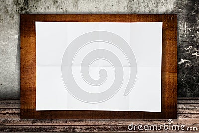 Blank white paper texture on the wood wall.