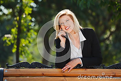 Blond business woman calling on the cell phone