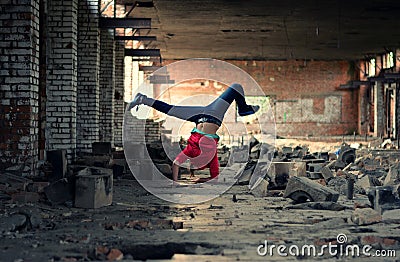 Blond girl dancing break dance in the old brickworks