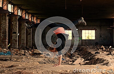 Blond girl dancing break dance in the old brickworks