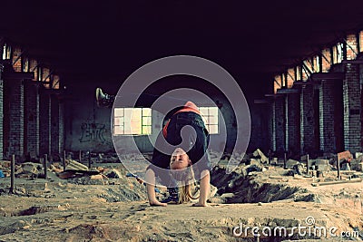 Blond girl dancing break dance in the old brickworks