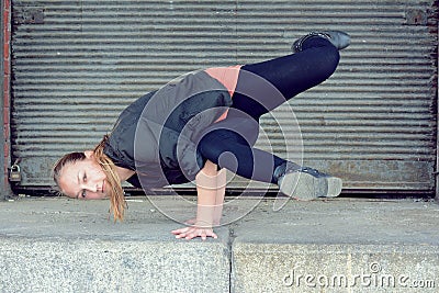 Blond girl dancing break dance on the street