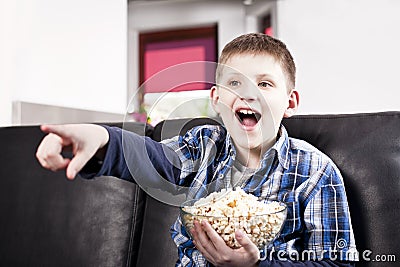 http://thumbs.dreamstime.com/x/blond-happy-boy-watching-tv-eating-popcorn-24012468.jpg