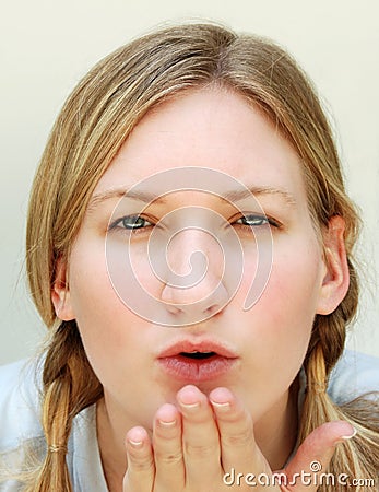 Blond woman blowing kiss