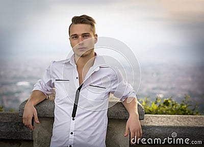 Blond young man on top of hill above Turin, Italy