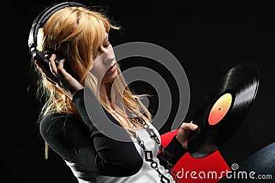 Blonde girl listening music with headphones