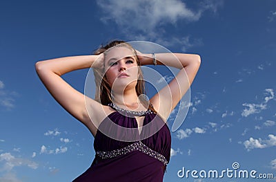 Blonde lady in evening dress with blue sky