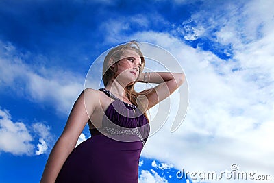 Blonde lady in evening dress with blue sky