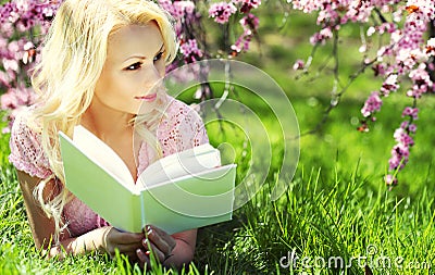 Blonde Woman with Book under Cherry Blossom