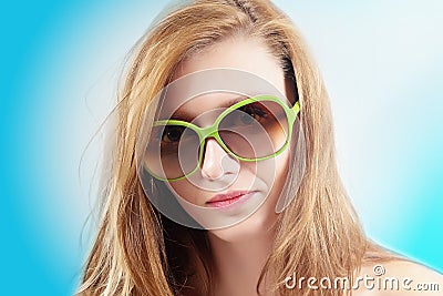 Blonde young woman with green glasses