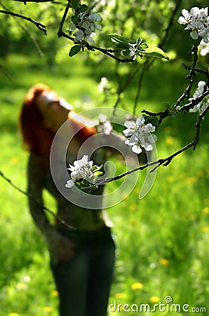 Spring garden and silhouette of the woman