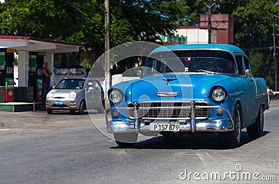 A blue classic car drived on the street in havana city