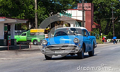 A blue classic car on the street in cuba