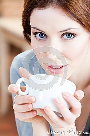 Blue-eyed woman with cup of tea