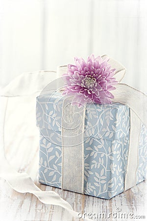 Blue floral gift box tied up with white ribbon