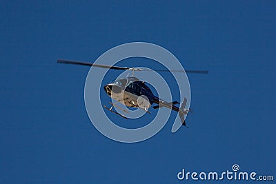 Blue helicopter in flight