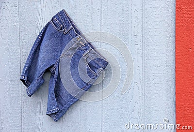 Blue Jean Capri Shorts on blue grey wall red border