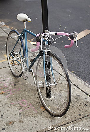 Blue and Pink Bicycle on the Sidewalk