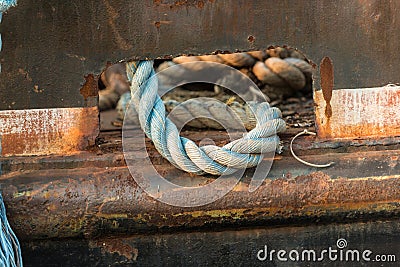 Blue rope left laying on the deck of a deep sea fishing and oyst