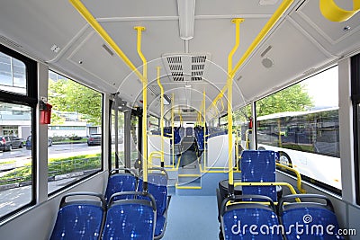 Blue seats inside saloon of empty city bus