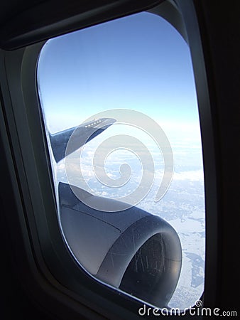 Blue sky behind plane window