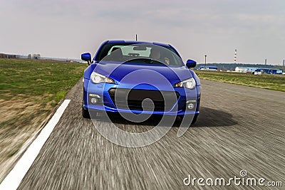 Blue sport car on race way