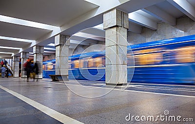 Blue train in motion at subway station