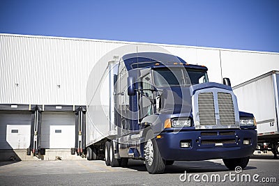 Blue Transport Truck Docking in yard
