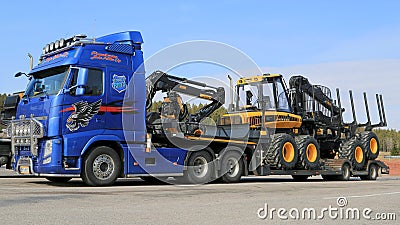 Blue Volvo FH13 Truck Hauling Ponsse Forestry Machinery