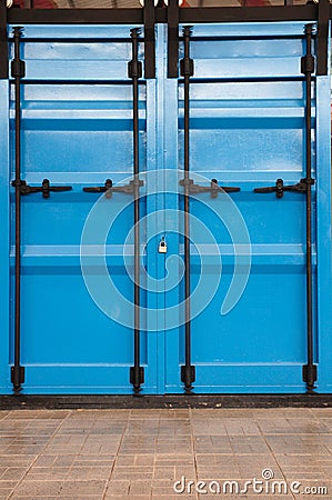 Blue warehouse gate locked from outside.