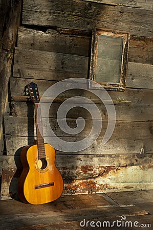 Blues guitar the old wooden wall as background
