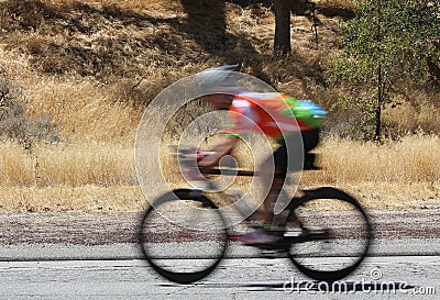 A blurred image of a speeding bike rider.