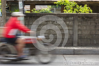 Blurred image of vehicles running on street in Thailand (motion