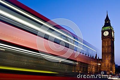 Blurred London double-decker bus passes Big Ben