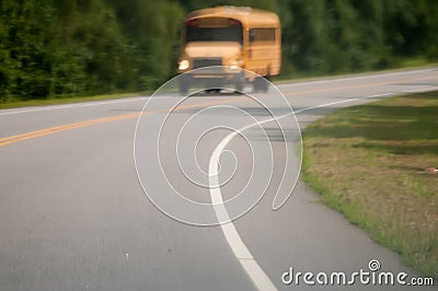 Blurry abstract view of school bus driving on road