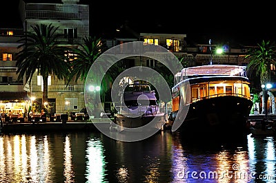 Boats docked at night in port of Podgora