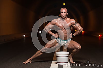 Bodybuilder Posing With Supplements For Copy Space