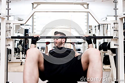 Bodybuilder training in the gym: chest - barbell incline bench