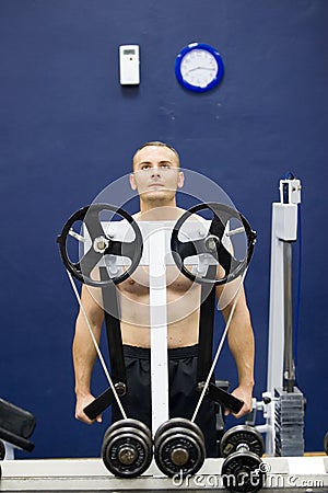 Bodybuilder with weight machine