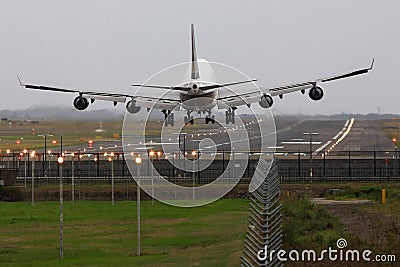 Boeing 747 jumbo jet landing on runway.