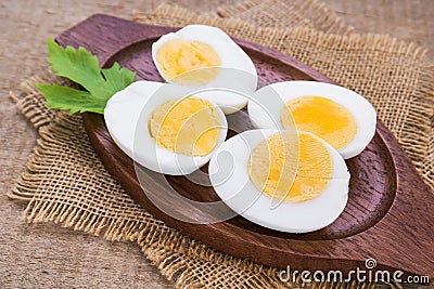Boiled eggs on wooden plate