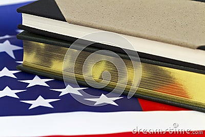 Book with gold pages on American flag