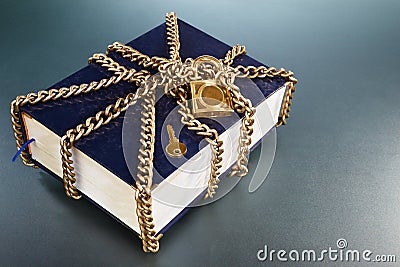 Book with golden chain and lock
