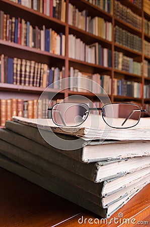 Books and glasses on library table